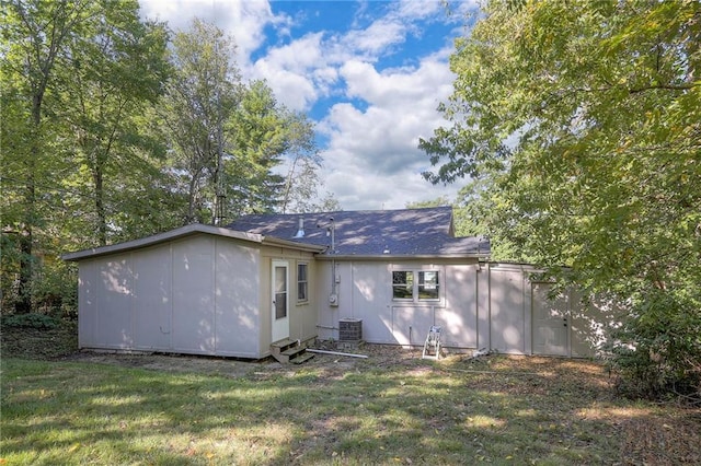 back of house with a lawn