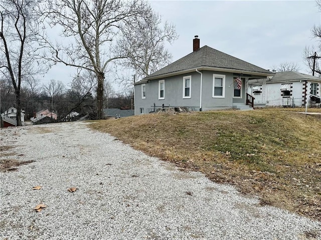 view of side of property featuring a yard