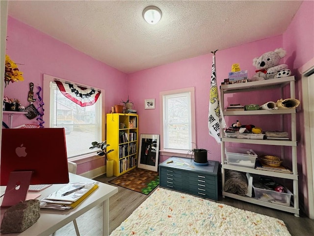 office area with wood-type flooring and a textured ceiling