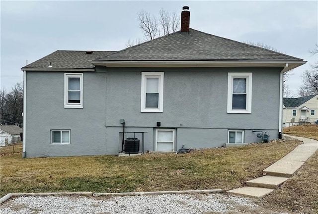 view of side of property featuring a lawn and central air condition unit