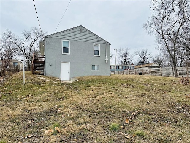 rear view of property featuring a yard