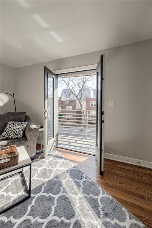 living room featuring baseboards and wood finished floors