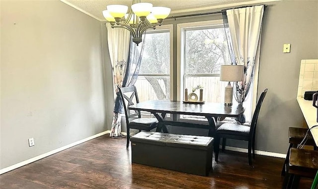 dining space with dark hardwood / wood-style flooring, ornamental molding, and a chandelier