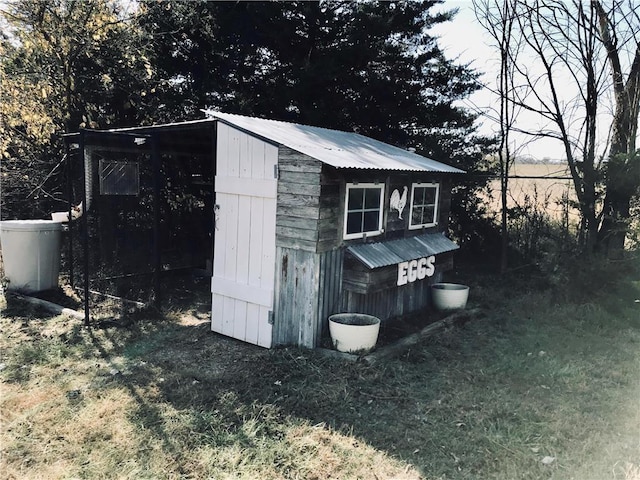 view of outbuilding featuring a lawn