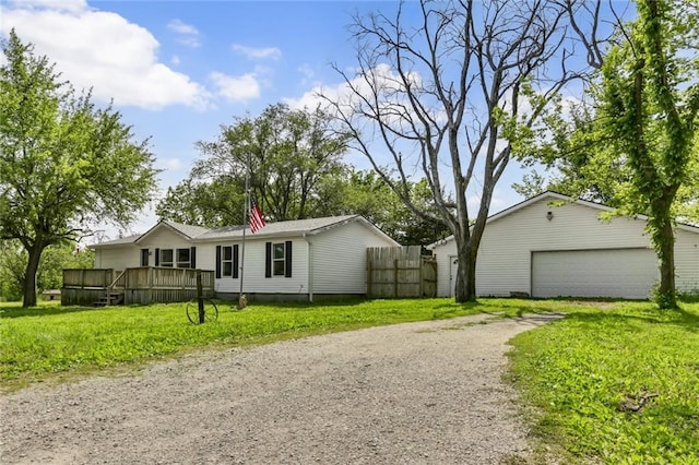 manufactured / mobile home with an outbuilding, a garage, and a deck