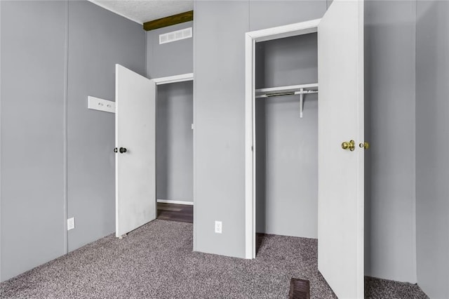 unfurnished bedroom with carpet floors and a closet
