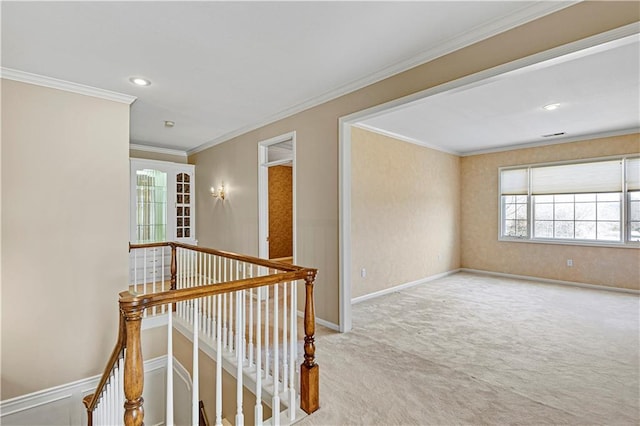 corridor featuring an upstairs landing, baseboards, carpet, and ornamental molding