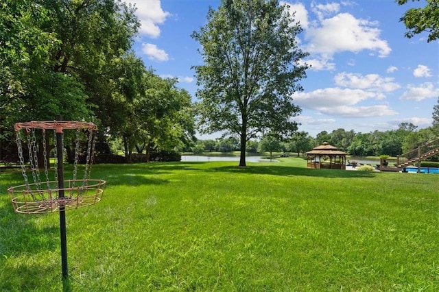 view of yard featuring a gazebo and a water view