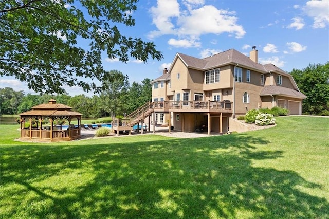 back of house featuring a gazebo, a lawn, stairs, and a garage