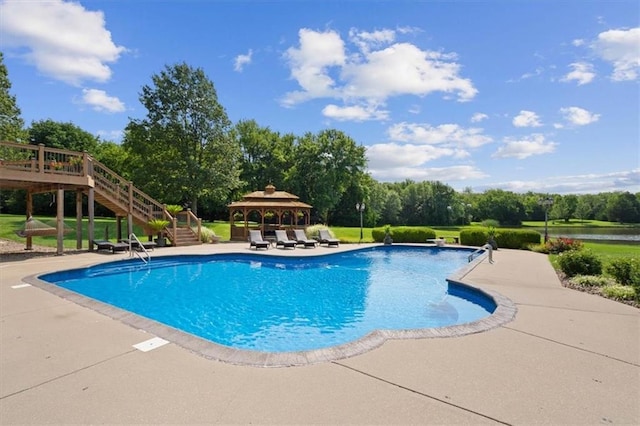 outdoor pool with a deck, a patio, a gazebo, a diving board, and stairs