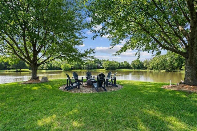 view of yard with a water view and an outdoor fire pit