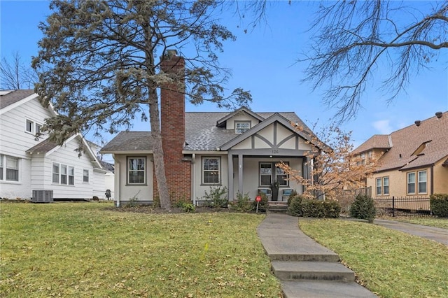 view of front of property with a porch, a front yard, and cooling unit