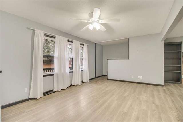 empty room featuring ceiling fan and light hardwood / wood-style floors