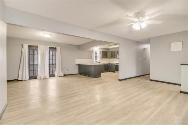 unfurnished living room with ceiling fan and light hardwood / wood-style floors