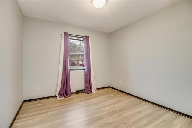 unfurnished room with light wood-type flooring