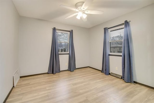 empty room featuring ceiling fan and light hardwood / wood-style floors