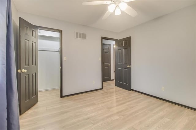 unfurnished bedroom with light hardwood / wood-style floors, a closet, and ceiling fan