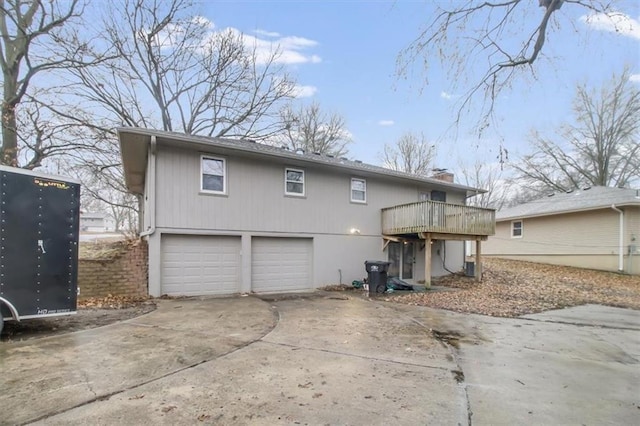 back of house featuring a wooden deck and a garage