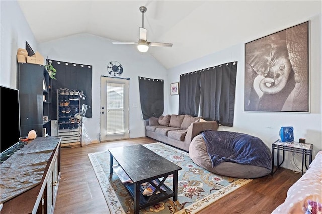 living room with ceiling fan, vaulted ceiling, and wood finished floors