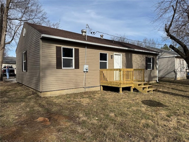 rear view of house featuring a yard