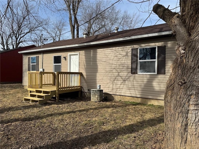 rear view of property with cooling unit