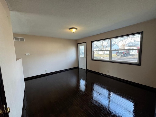 empty room featuring dark wood-type flooring