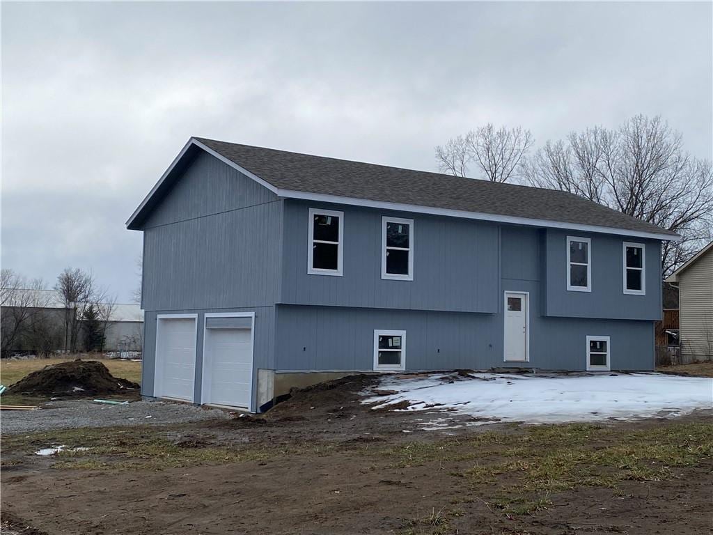 back of house featuring a garage