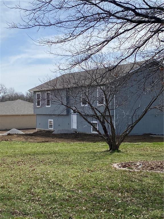 123 NW 171st Rd, Warrensburg, MO 64093 - rear view of house featuring a yard
