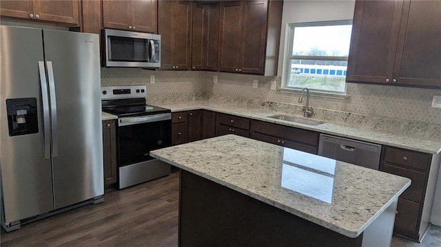 123 NW 171st Rd, Warrensburg, MO 64093 - kitchen with appliances with stainless steel finishes, a sink, dark wood finished floors, backsplash, and dark brown cabinets