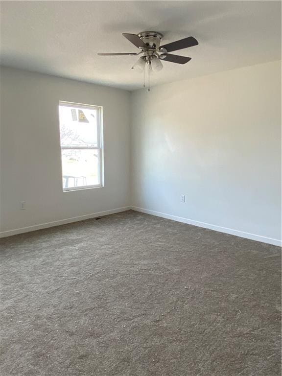 123 NW 171st Rd, Warrensburg, MO 64093 - spare room with dark carpet, baseboards, and ceiling fan