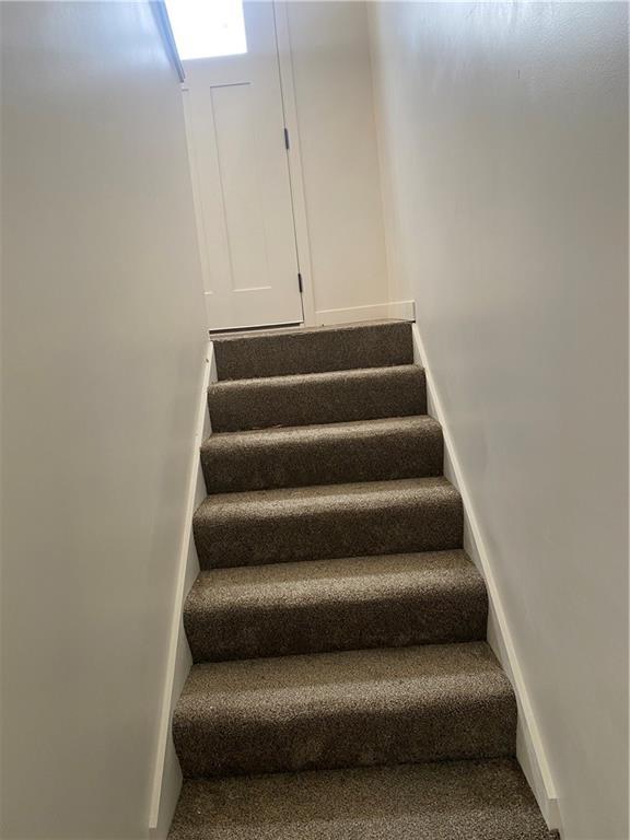 123 NW 171st Rd, Warrensburg, MO 64093 - stairway featuring baseboards and carpet flooring
