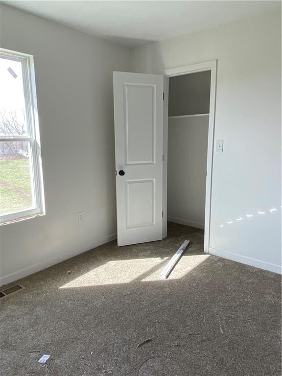 123 NW 171st Rd, Warrensburg, MO 64093 - unfurnished bedroom featuring carpet, a closet, and baseboards