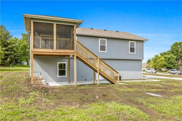 123 NW 171st Rd, Warrensburg, MO 64093 - rear view of house with stairway, a sunroom, and a lawn
