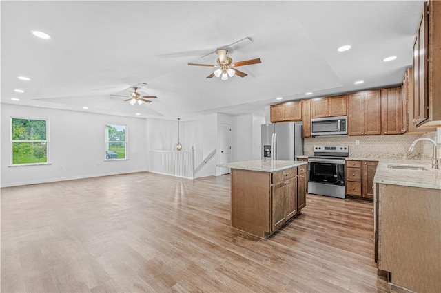 123 NW 171st Rd, Warrensburg, MO 64093 - kitchen featuring appliances with stainless steel finishes, a sink, a kitchen island, ceiling fan, and tasteful backsplash