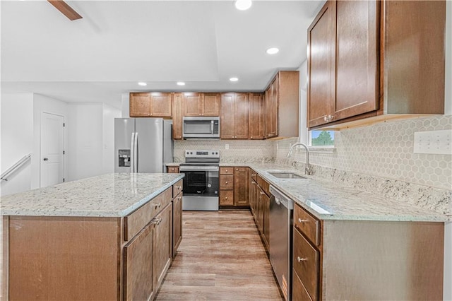 123 NW 171st Rd, Warrensburg, MO 64093 - kitchen featuring stainless steel appliances, a sink, light wood-type flooring, recessed lighting, and a kitchen island