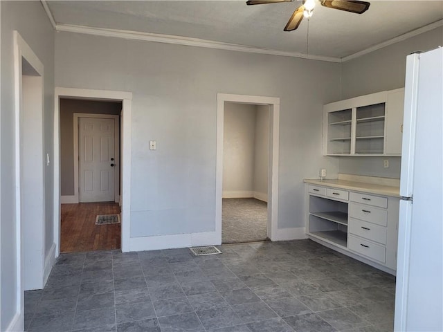 kitchen with visible vents, white cabinetry, ornamental molding, freestanding refrigerator, and open shelves