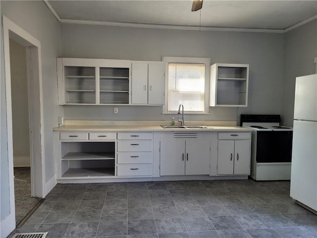 kitchen featuring freestanding refrigerator, a sink, range with electric cooktop, and open shelves