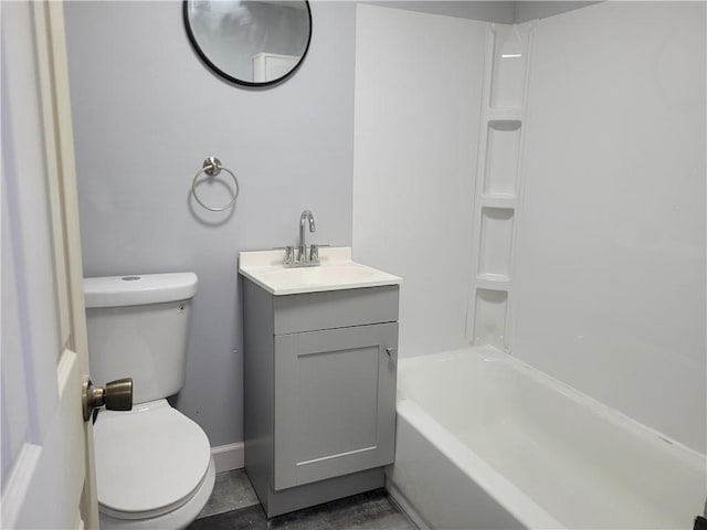 full bath featuring baseboards, shower / bathing tub combination, vanity, and toilet