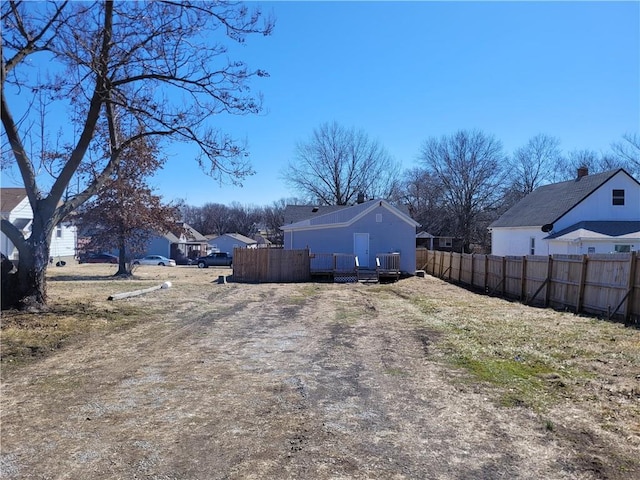 view of yard featuring a deck and fence