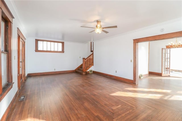 unfurnished room with crown molding, ceiling fan with notable chandelier, and dark parquet floors