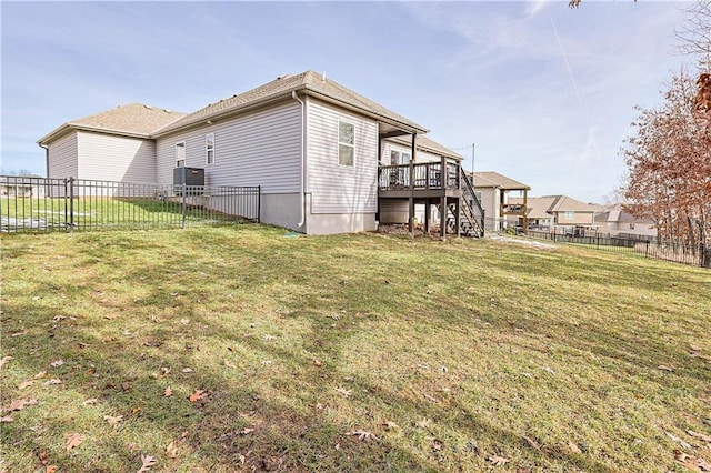 back of property featuring a wooden deck and a yard