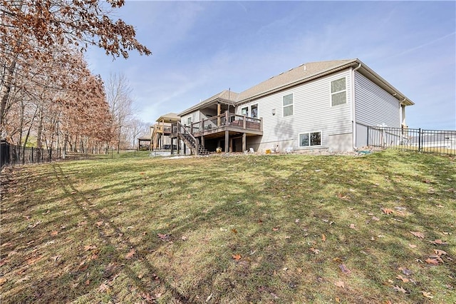 back of property featuring a lawn and a deck