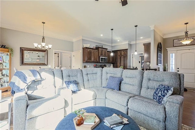 living room with ornamental molding, a chandelier, and hardwood / wood-style floors