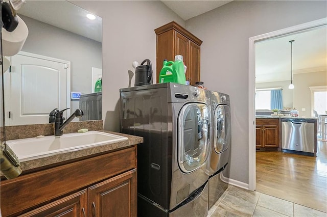 washroom with sink, cabinets, and independent washer and dryer