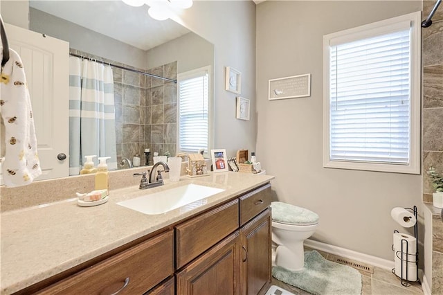 bathroom with vanity, toilet, and curtained shower