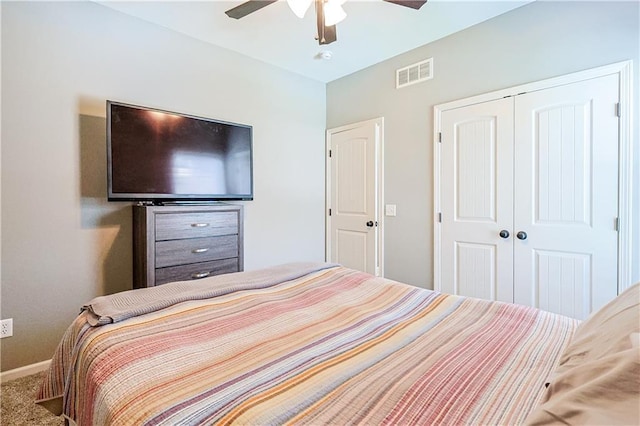 carpeted bedroom featuring a closet and ceiling fan