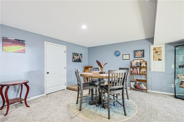 dining area featuring light carpet