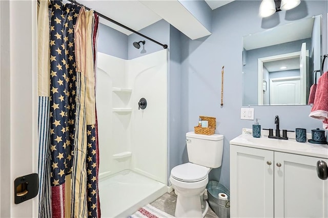 bathroom featuring toilet, vanity, and a shower with shower curtain