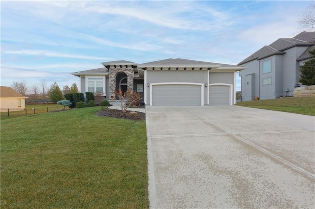 view of front of property featuring an attached garage, fence, stone siding, driveway, and a front lawn