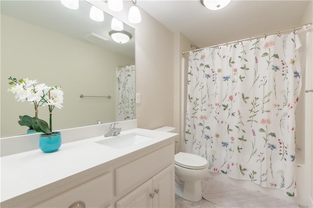 bathroom featuring shower / bath combo, vanity, and toilet